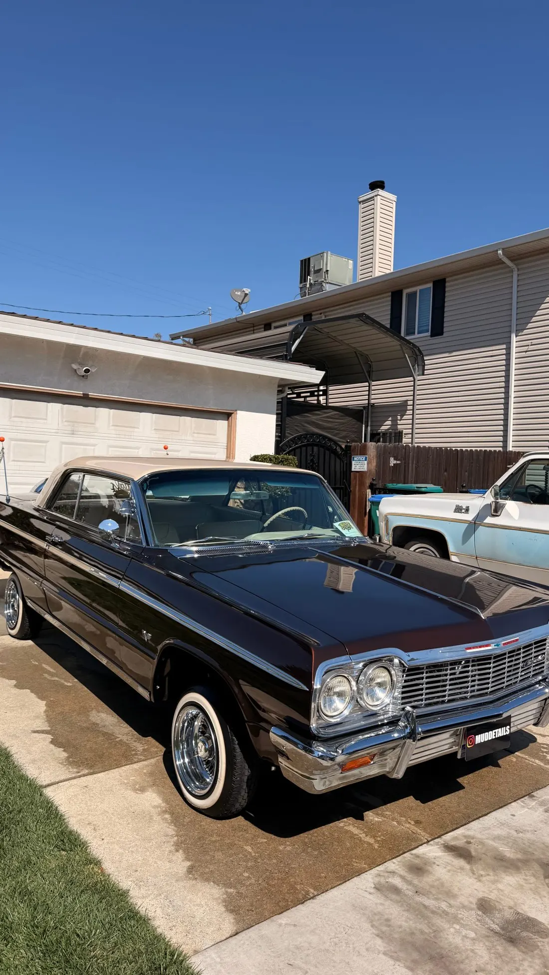 Classic black Chevrolet Impala lowrider detailed by Mud Details, gleaming in a Stockton driveway